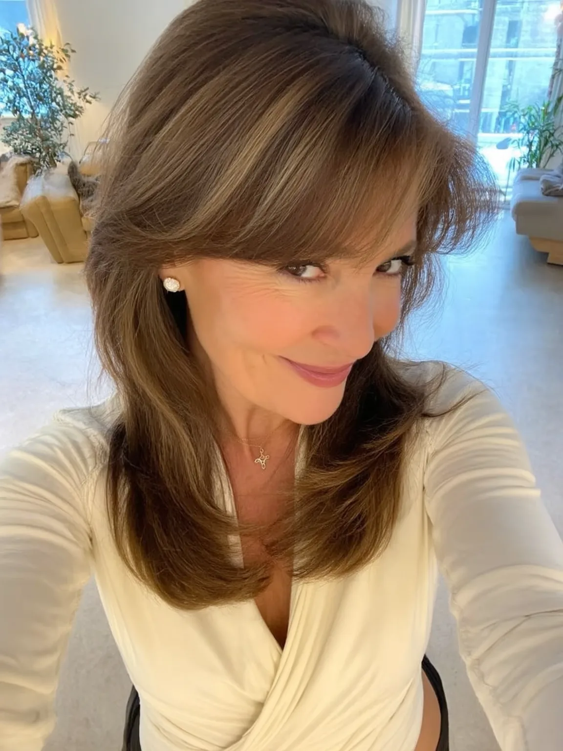 Long Straight Layers with Side-Swept Bangs and Caramel Highlights
